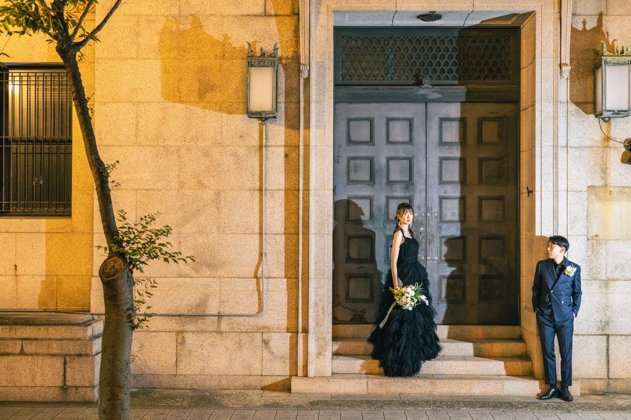 Night couple portrait at a grand historic doorway