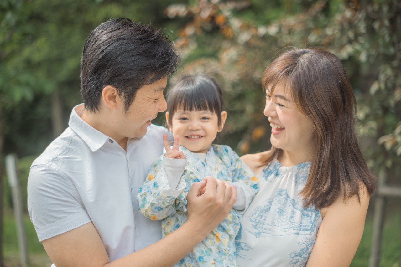 Osaka Castle Park close family portrait – father, mother and daughter, soft light