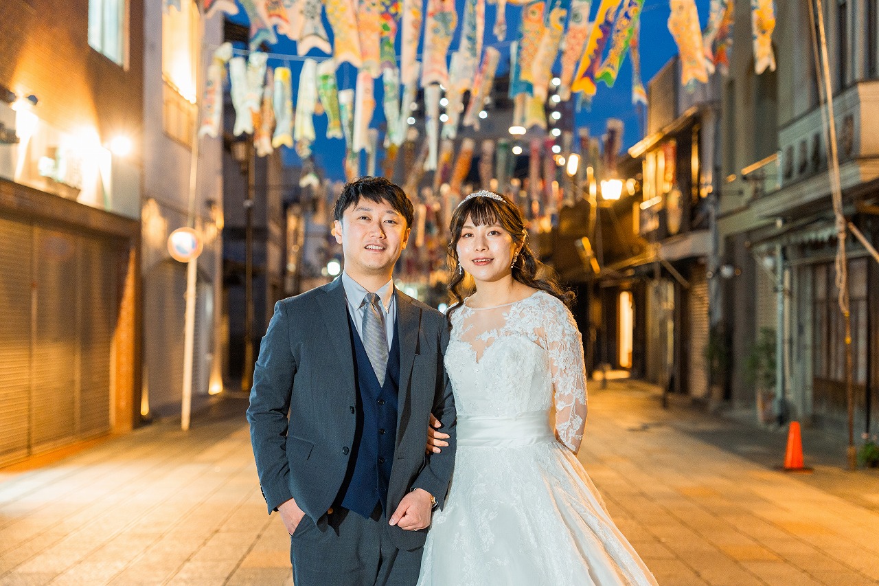 Kawagoe photoshoot evening couple portrait under festival streamers in a shopping street