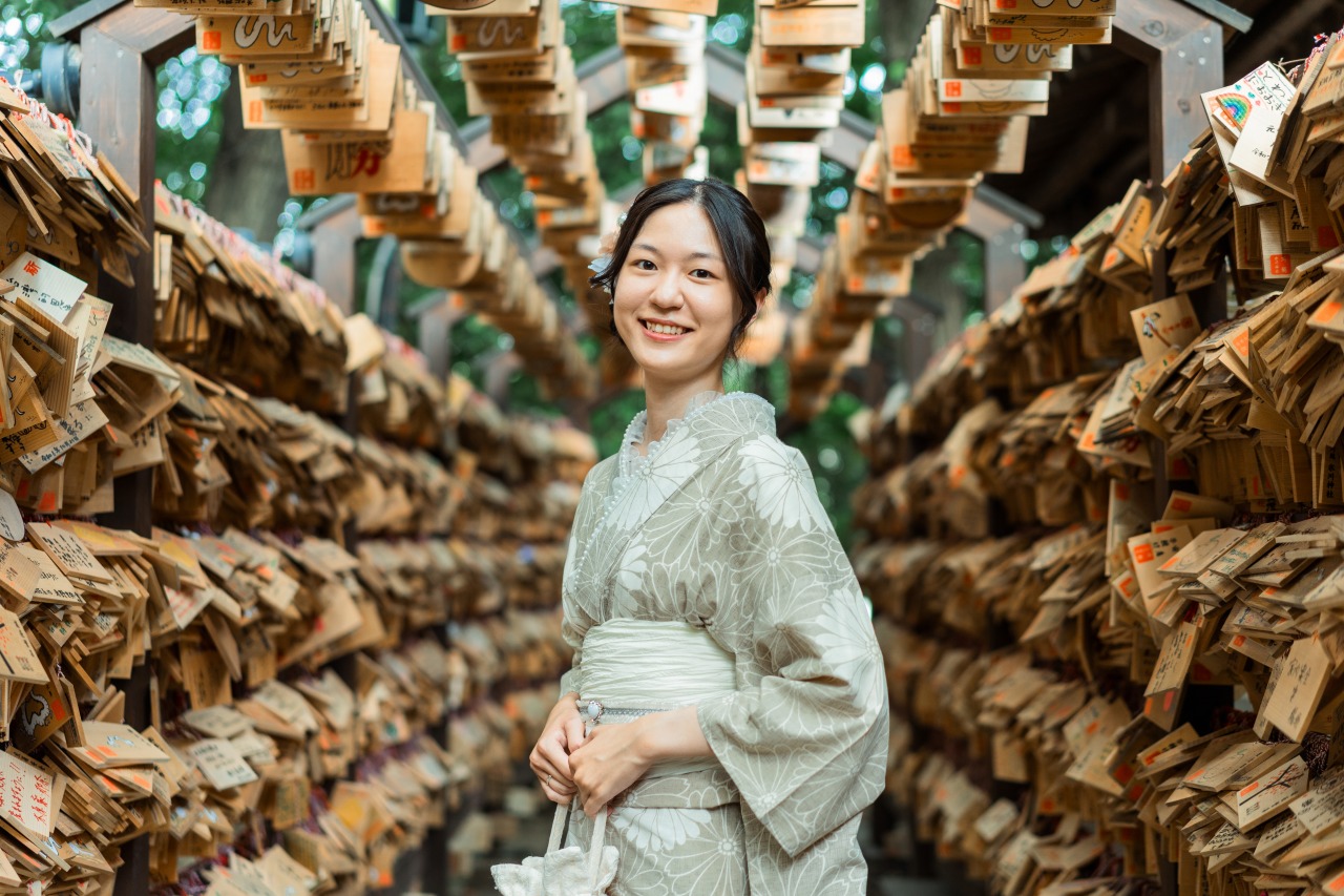 Hikawa Shrine portrait – woman in kimono under ema tunnel, shallow depth