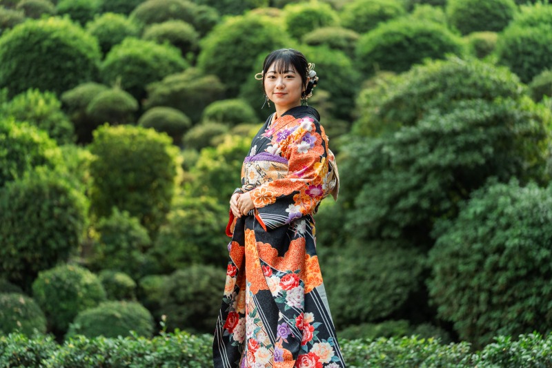 Tokyo garden kimono portrait - green topiary background, serene pose