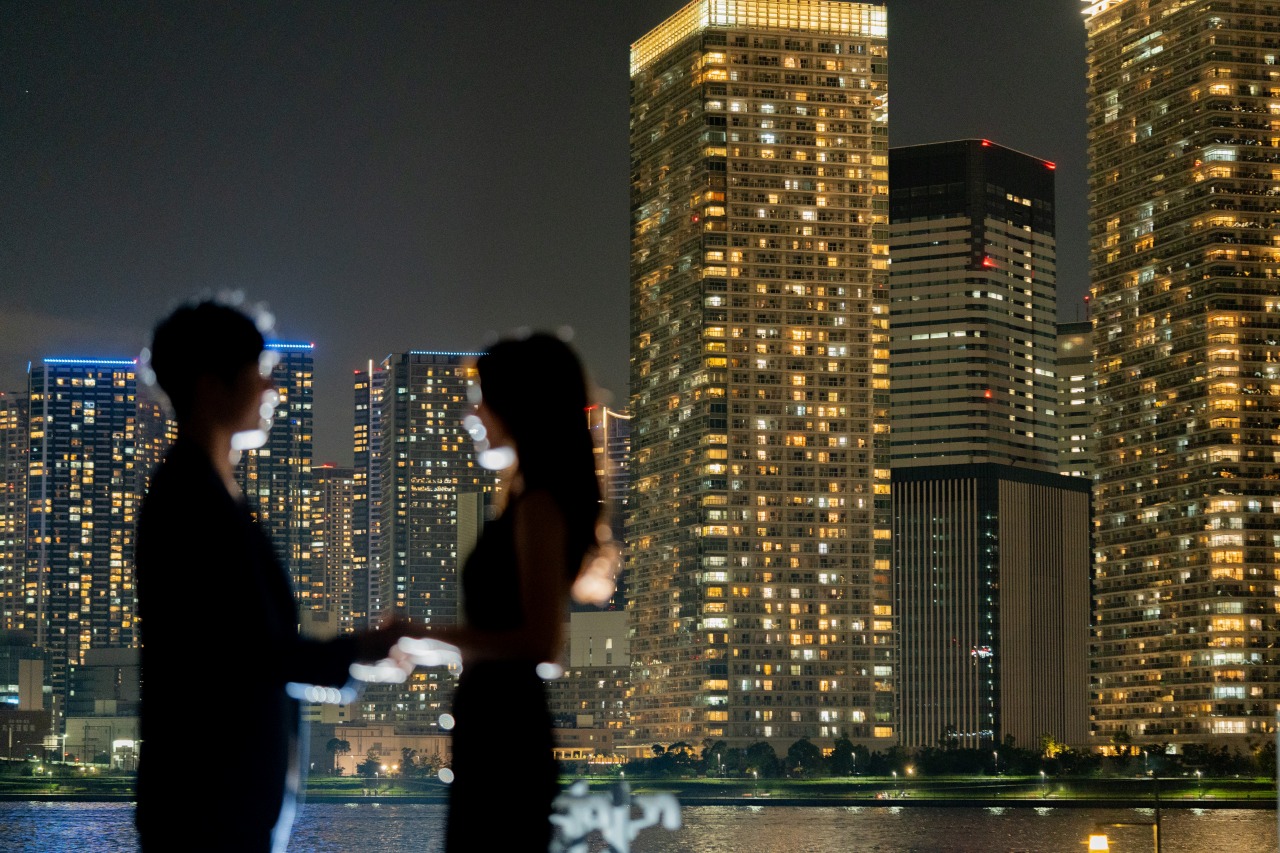 Tokyo night silhouette portrait by high-rise waterfront, romantic moment
