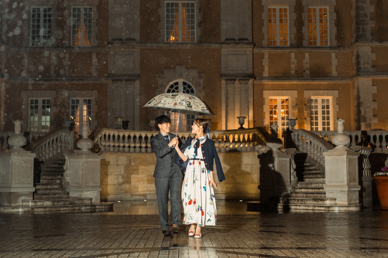 Tokyo night portrait in rain - couple with umbrella at European-style facade