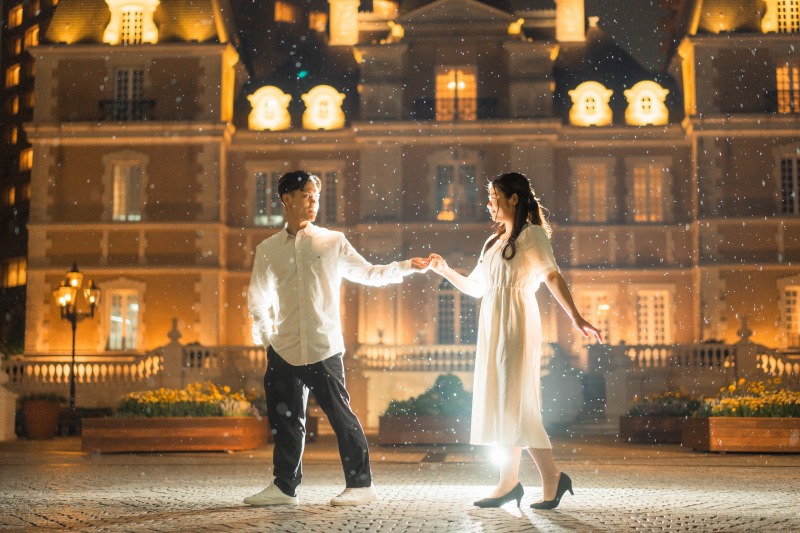 Tokyo night couple portrait - backlit dance in front of illuminated facade