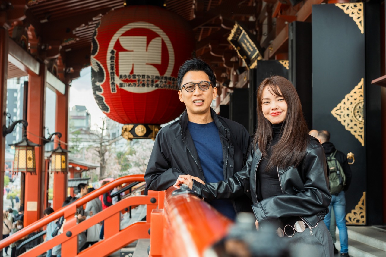 Asakusa shrine corridor portrait - couple by red lantern and bridge rail