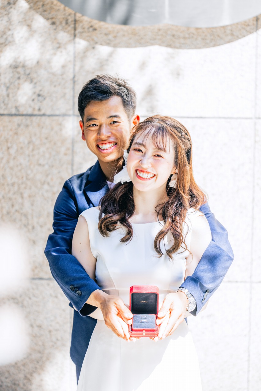 Couple showing an engagement ring box in Kobe