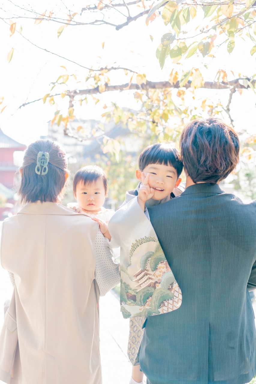西新井大師 七五三 家族写真 家族に囲まれて振り向く男の子の後ろ姿